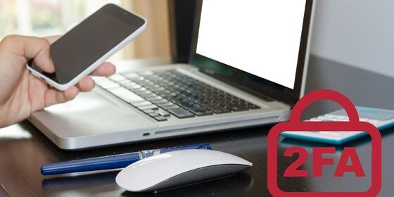 Photo shows a picture of a laptop, mobile and iPad on a table with the word 2FA on the lower right of the image.