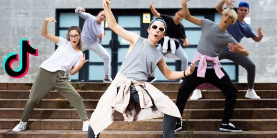 February_2023 Teenagers are dancing in a synchronized manner. The TikTok logo is on the right.